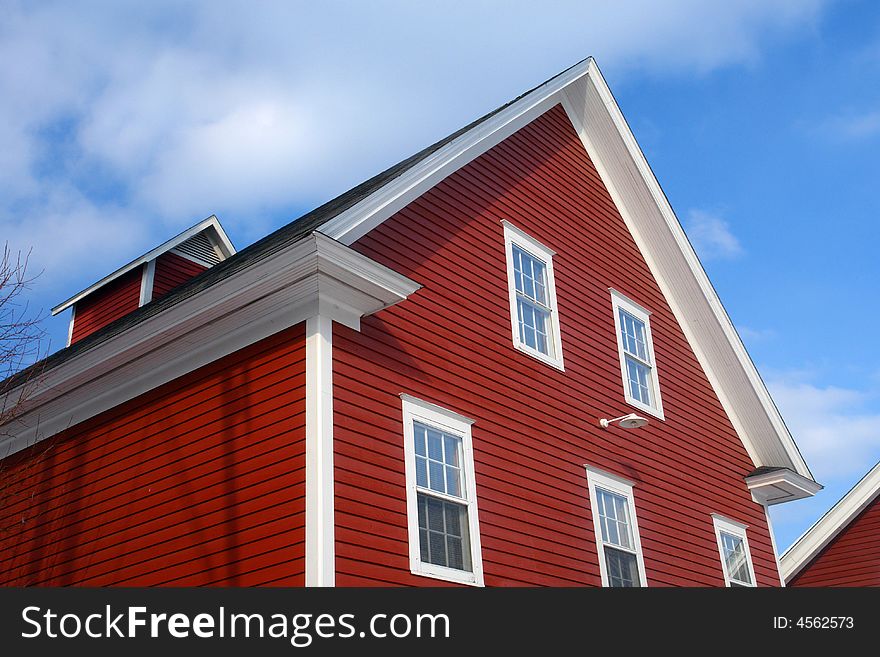 A picture of the top of a red barn roof. A picture of the top of a red barn roof