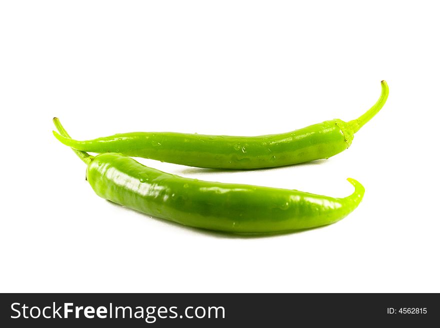 Two green peppers isolatad on white