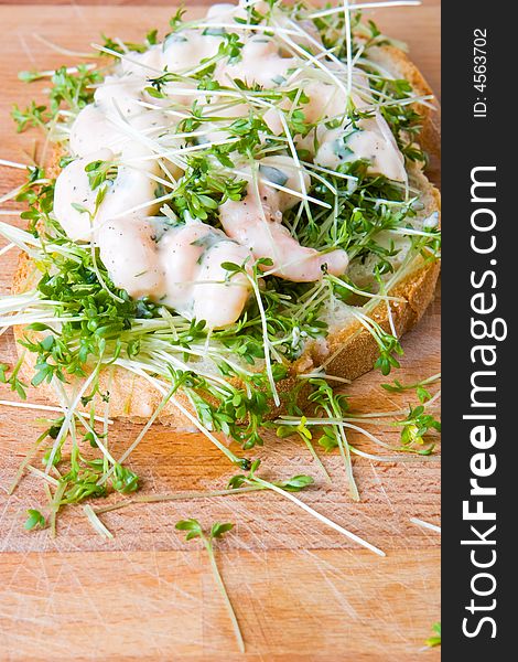 Prawn and cress sandwich on a wooden board
