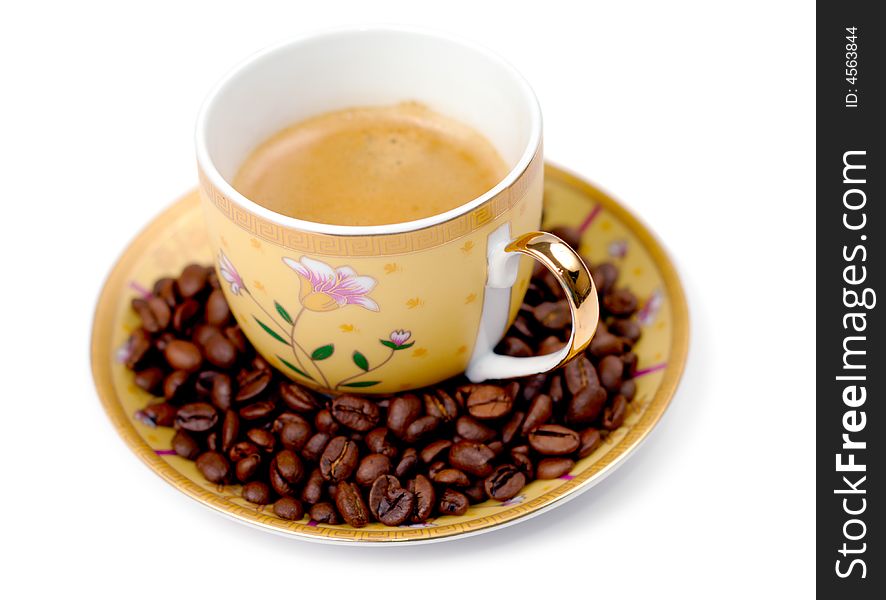 The cup of coffee and beans isolated over white