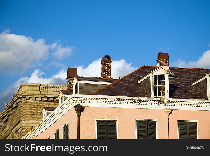 A view of the roof line and dormer windows or gables on the roof of an old building in the French quarter of New Orleans, Louisiana. A view of the roof line and dormer windows or gables on the roof of an old building in the French quarter of New Orleans, Louisiana.