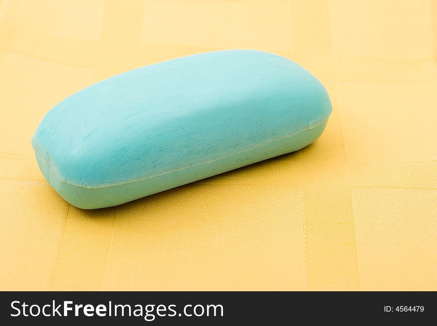 Piece of blue soap on yellow towel