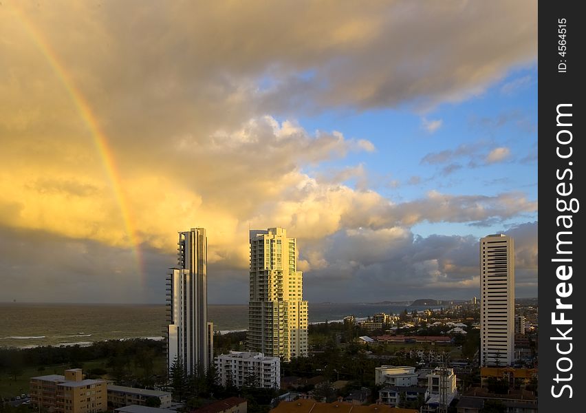 Tall buildings on beach at sunset taken from high vantage point with rainbow. Tall buildings on beach at sunset taken from high vantage point with rainbow