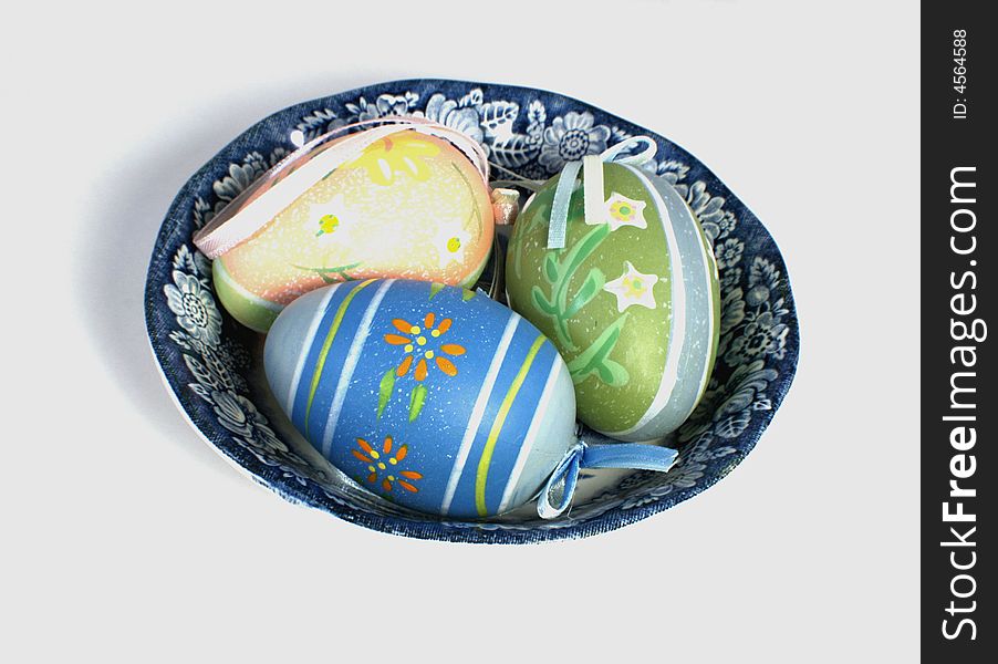 Three colored Easter eggs in decorative plate