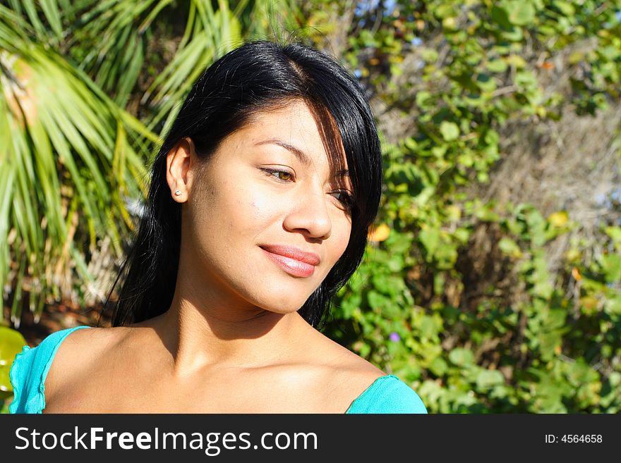 Attractive Woman Smiling with greenery in the Background. Attractive Woman Smiling with greenery in the Background.