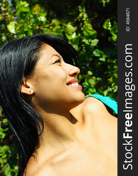 Attractive Woman Smiling with greenery in the Background. Attractive Woman Smiling with greenery in the Background.