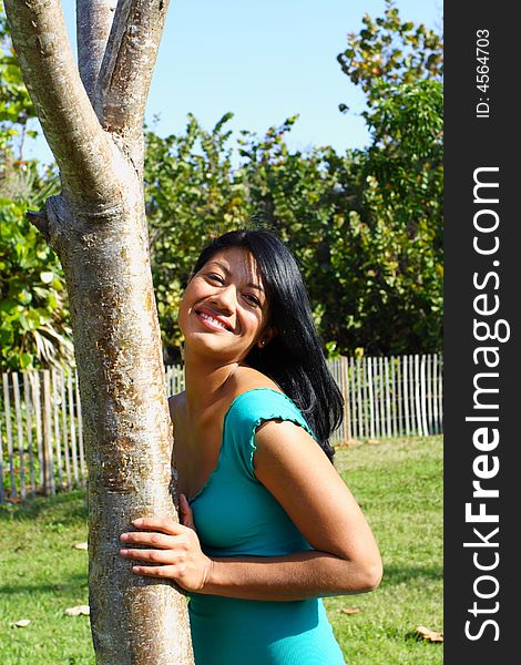 Woman Leaning on a tree at the park