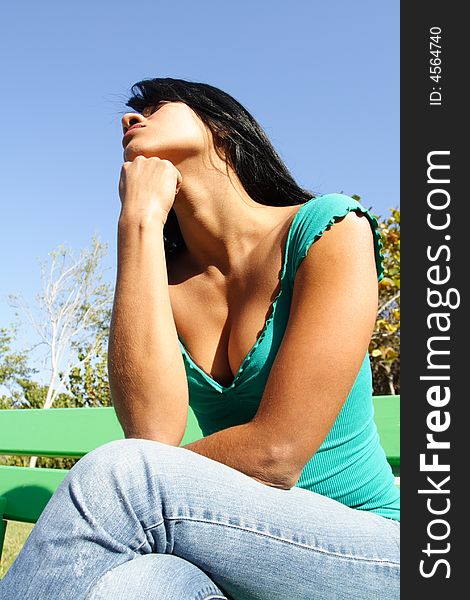 Woman sitting on a bench exposing her neck