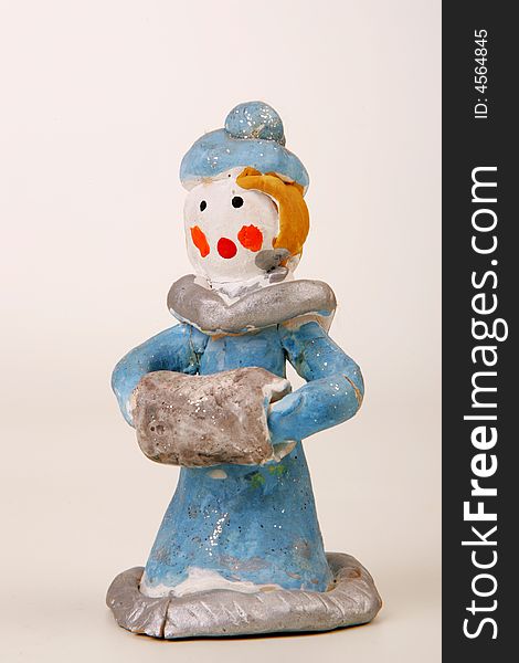 A painted clay figure of young lady in blue. A painted clay figure of young lady in blue