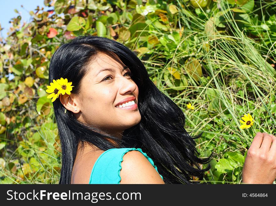 Attractive Woman Smiling with greenery in the Background. Attractive Woman Smiling with greenery in the Background.