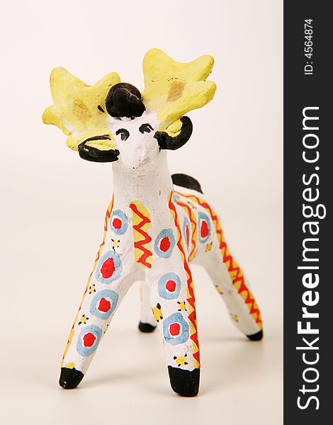 A painted clay statuette of male deer. A painted clay statuette of male deer