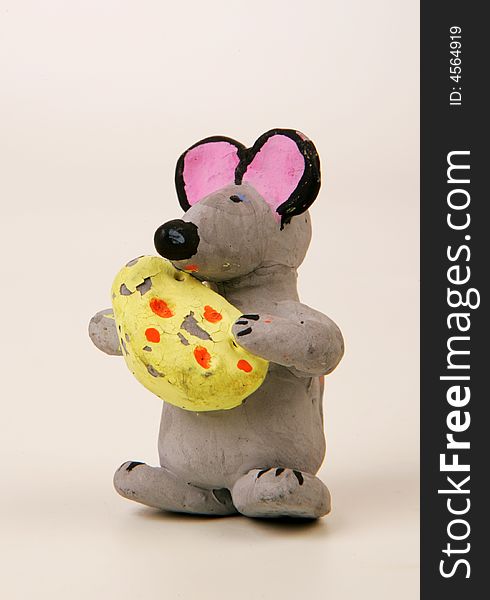 A terracotta figurine of a mouse with cheese