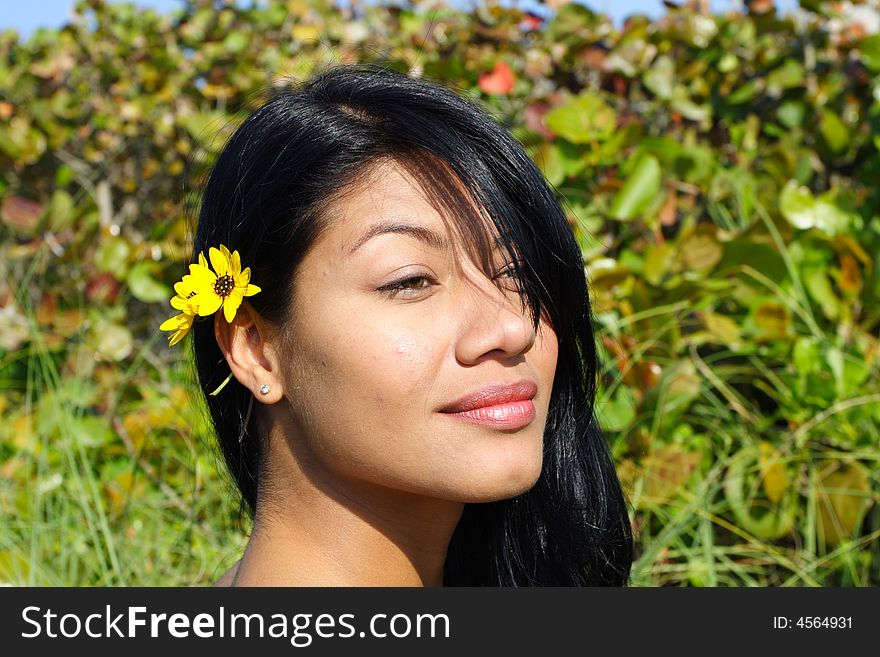 Attractive Woman Smiling with greenery in the Background. Attractive Woman Smiling with greenery in the Background.