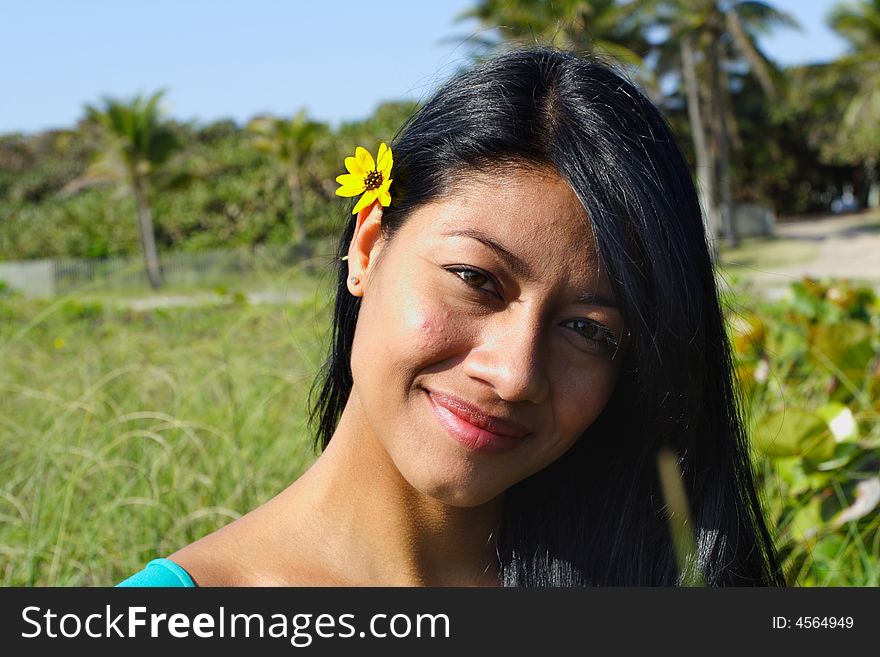 Attractive Woman Smiling with greenery in the Background. Attractive Woman Smiling with greenery in the Background.