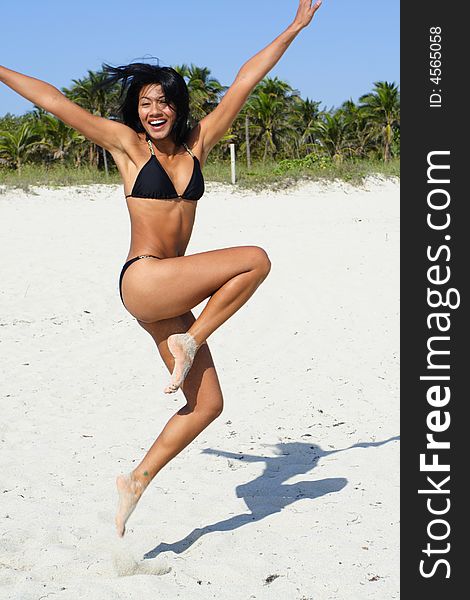 Mid air shot of a woman jumping and reaching out her arms. Mid air shot of a woman jumping and reaching out her arms