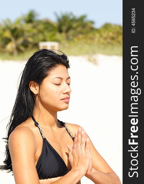 Beautiful young woman on the beach doing yoga exercises. Beautiful young woman on the beach doing yoga exercises.