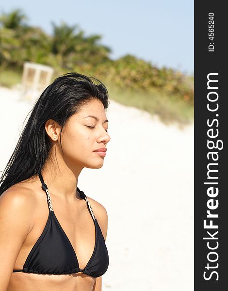 Woman Meditating At The Beach