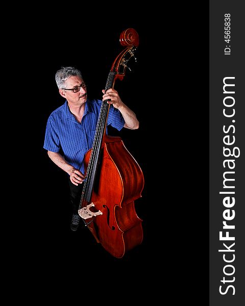 A musician playing a double bass on a black background. A musician playing a double bass on a black background