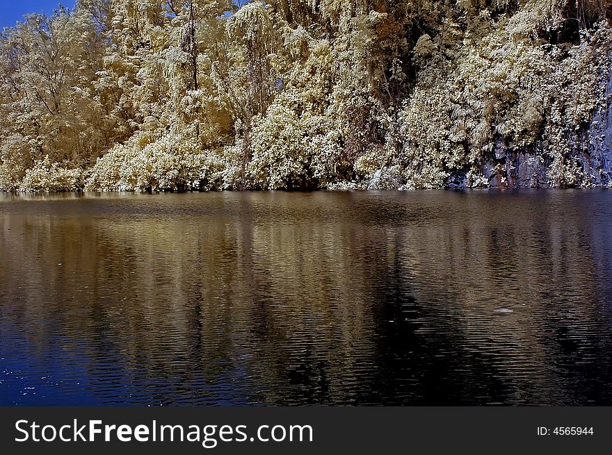 Infrared photo â€“ lake, rock, reflection and tree in the parks