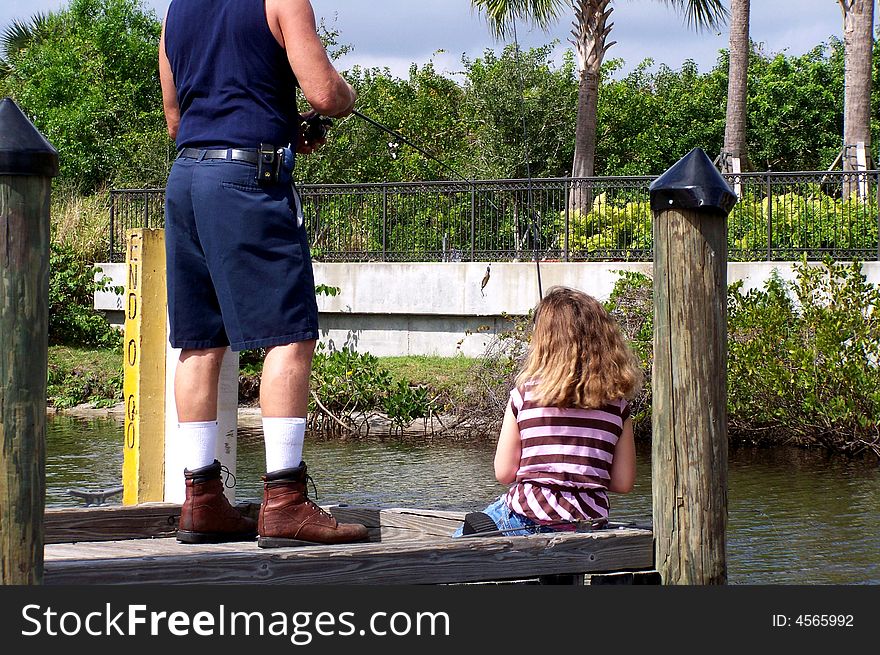 Jazzy watches intently to learn how to fish off dock of St. Lucie River. Jazzy watches intently to learn how to fish off dock of St. Lucie River