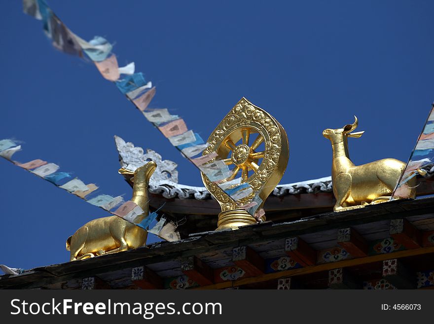 Golden signage of Tibetan Buddhism, on the roof of the temple