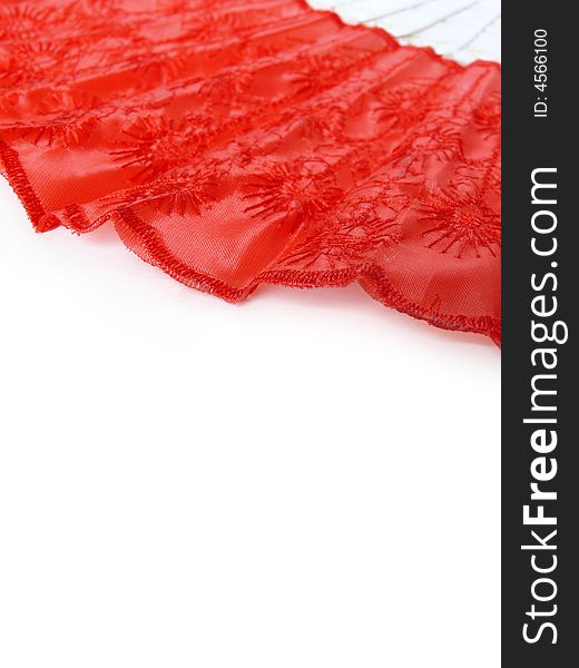 Part of red fan lying on white surface. Abstract red and white background. Part of red fan lying on white surface. Abstract red and white background.