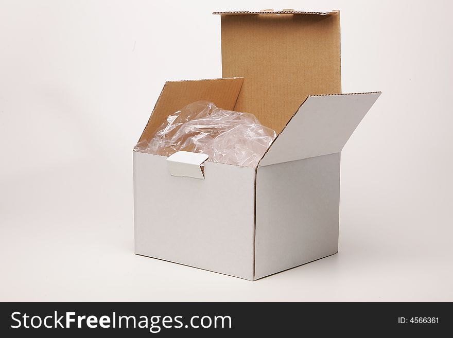 A white cardboard box on white surface. A white cardboard box on white surface