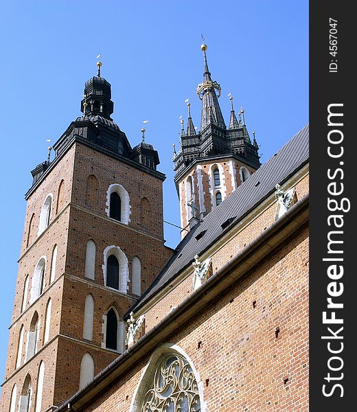 Towers of Cracovian Mariacki church in old city in the the centre of the Cracow.View from the side of antique the square of mariacki..