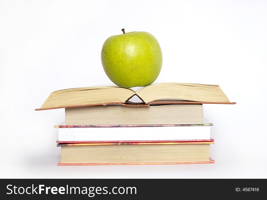 Green apple and stack of books