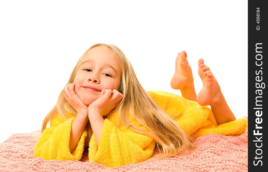 Pretty young girl lying on a bed and dreaming