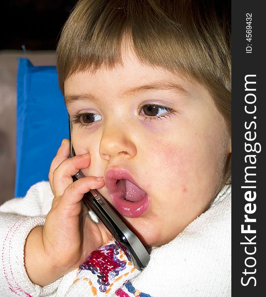 Adorable little girl speaks to the phone