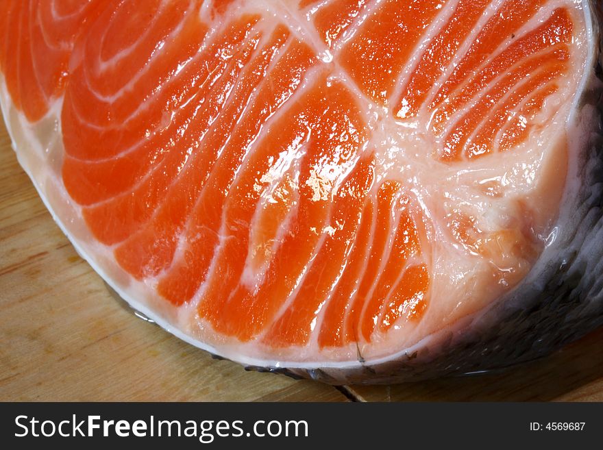 Succulent fresh piece of a salmon on a wooden board