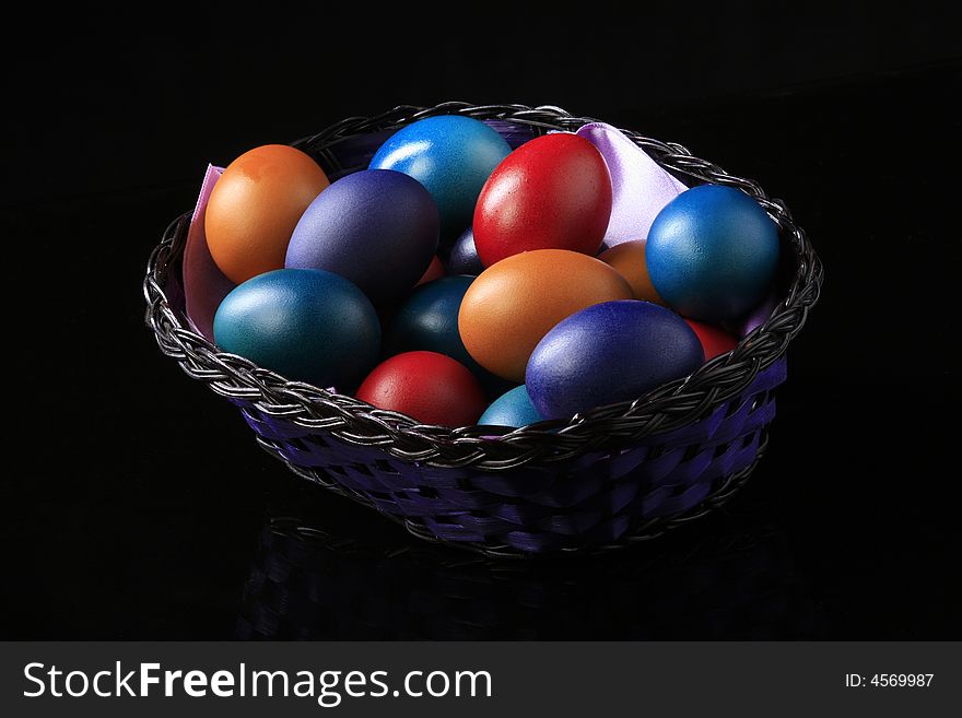 Colored eggs are standing in the basket. Colored eggs are standing in the basket