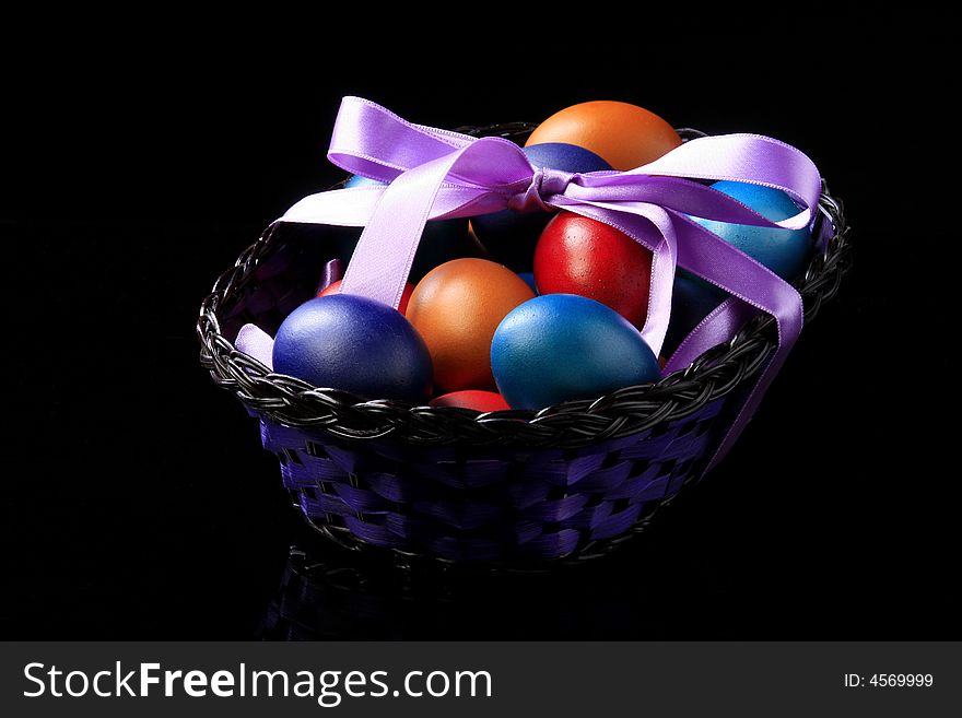 Colored eggs are standing in the basket. Colored eggs are standing in the basket