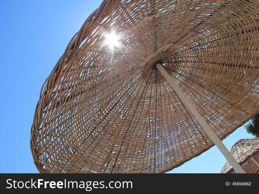 The sun which is translucent through a beach umbrella