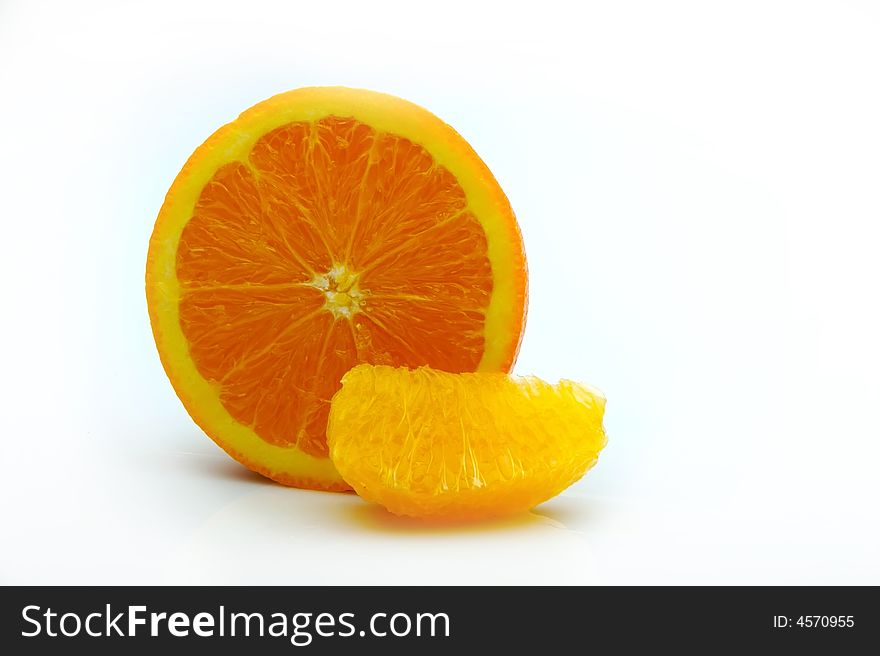 Half an orange with a segment on white room for text on the side