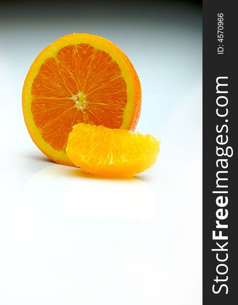 Half an orange with a segment on white room for text