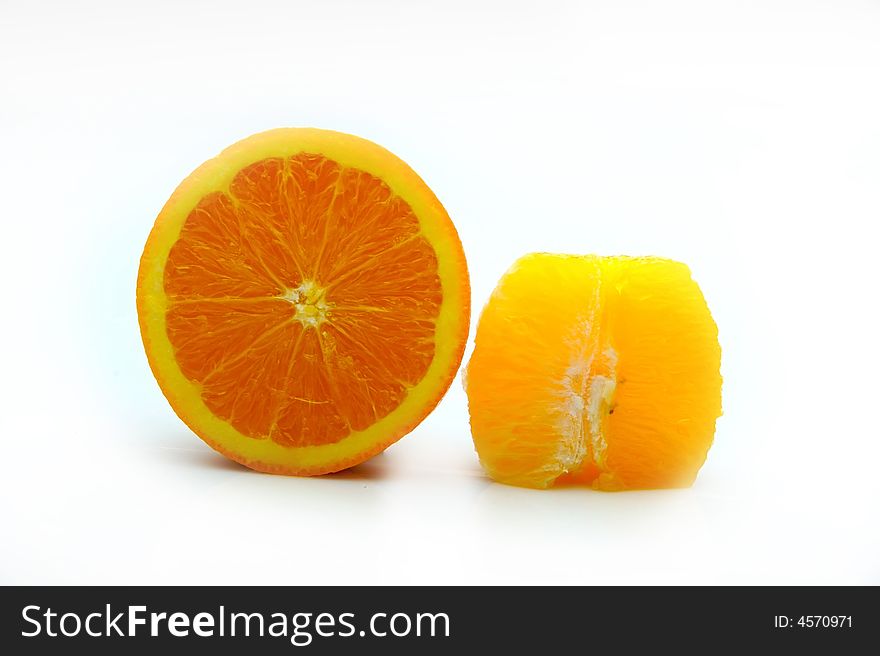 Half an orange with peel on and half segment without on white
