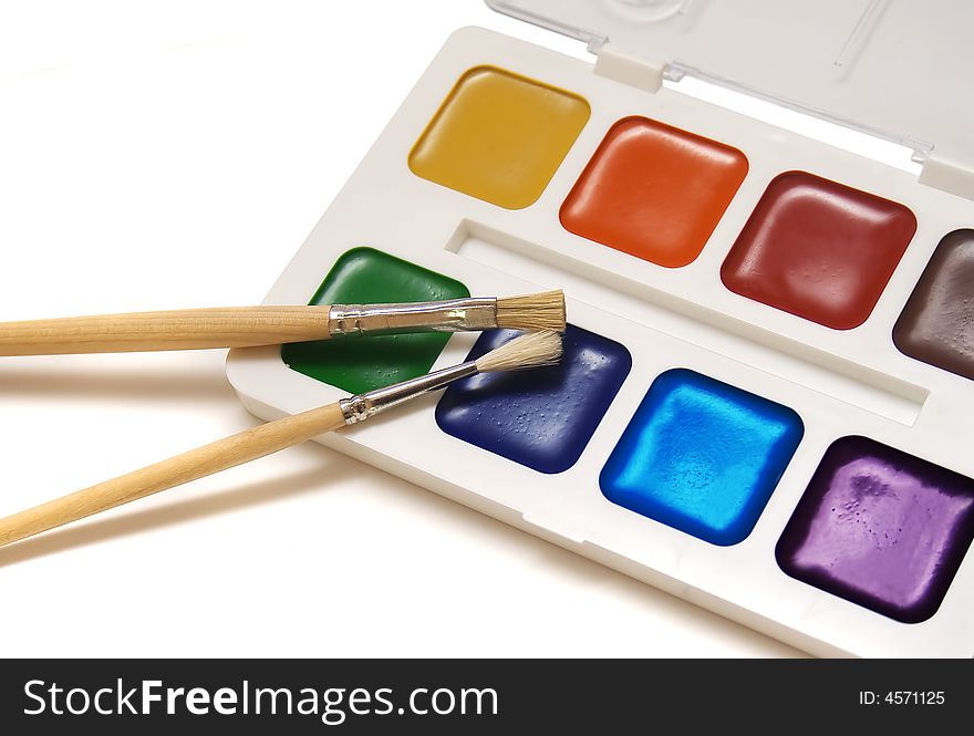 Brushes and paint isolated on white