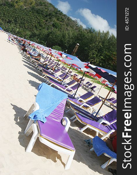 Rows of colorful beach chairs and umbrellas at the beach.