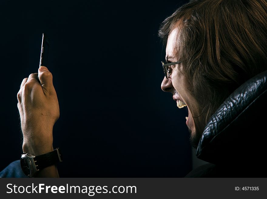 young man screaming at phone