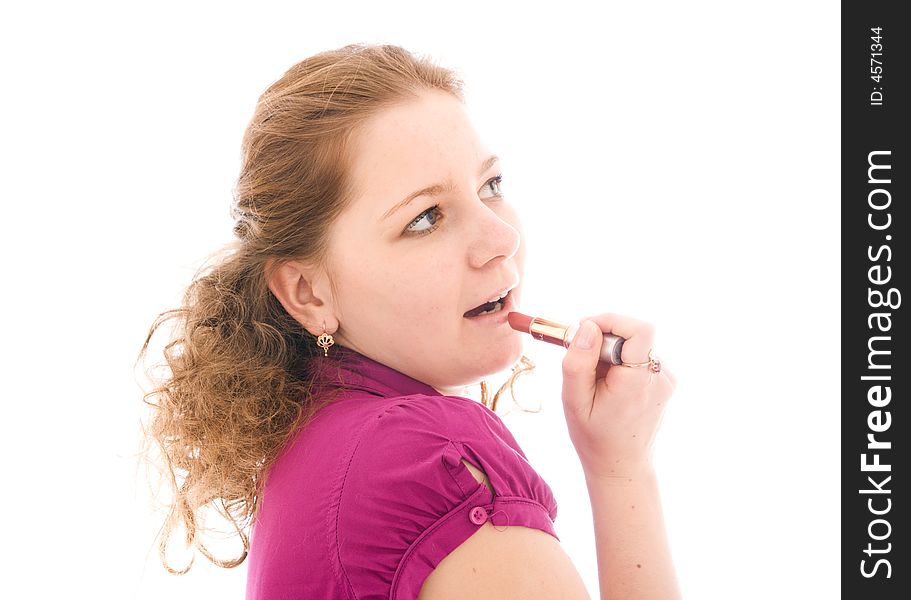 The girl does a make-up isolated on a white background