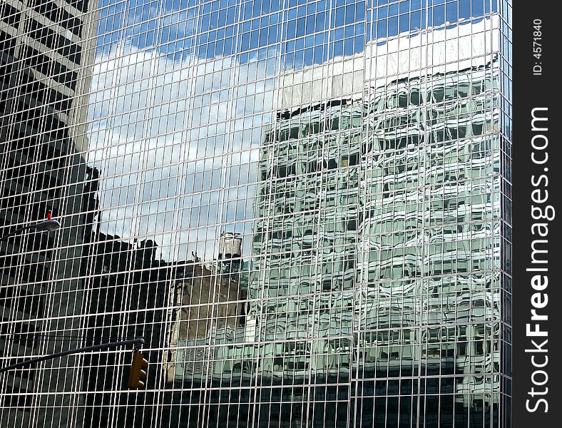 Reflections of buildings, sky and clouds in glass buildings, Manhattan, New York. Reflections of buildings, sky and clouds in glass buildings, Manhattan, New York