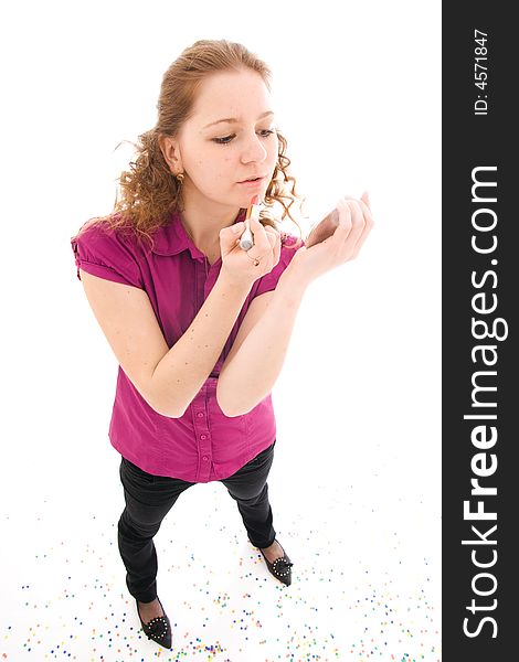 The girl does a make-up isolated on a white background