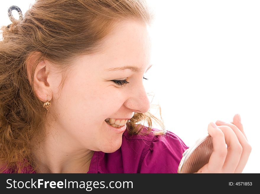 The girl does a make-up isolated on a white background