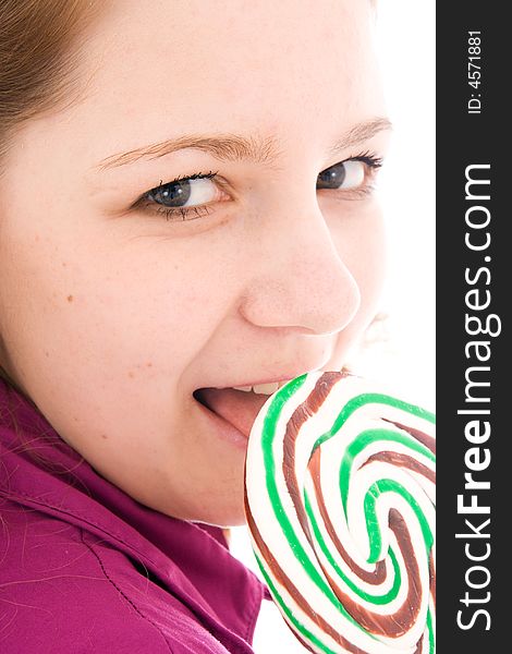 The girl with a sugar candy isolated on a white background