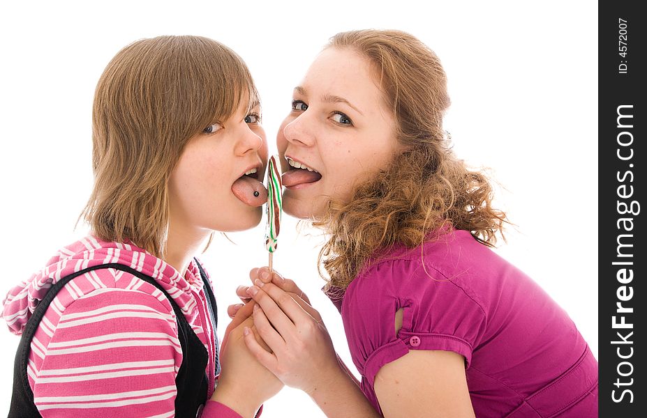 The two girls with a sugar candy isolated on a white background