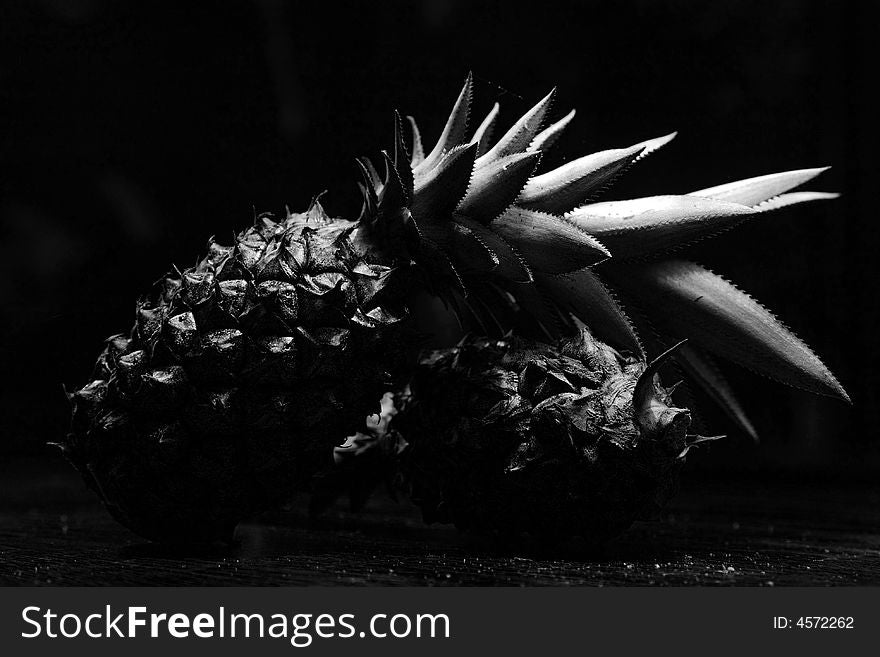 2 pineapples isolated in wood background