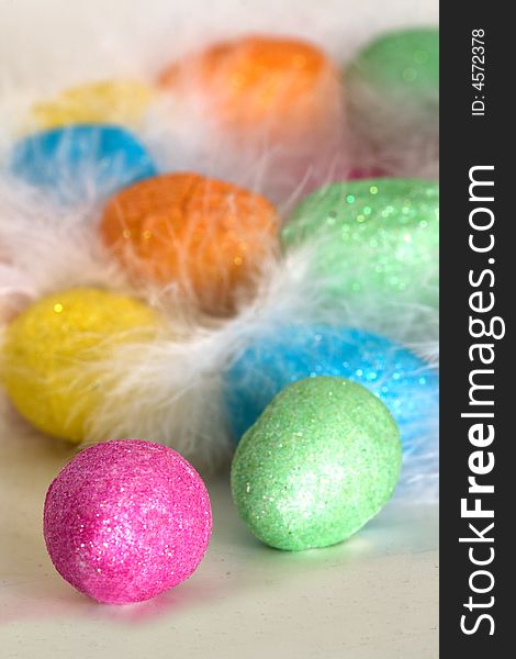 Easter eggs in the nest with white feather