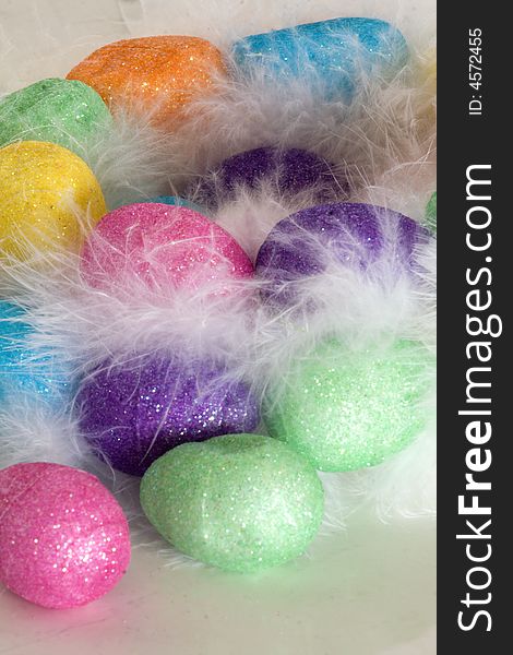 Easter eggs in the nest with white feather